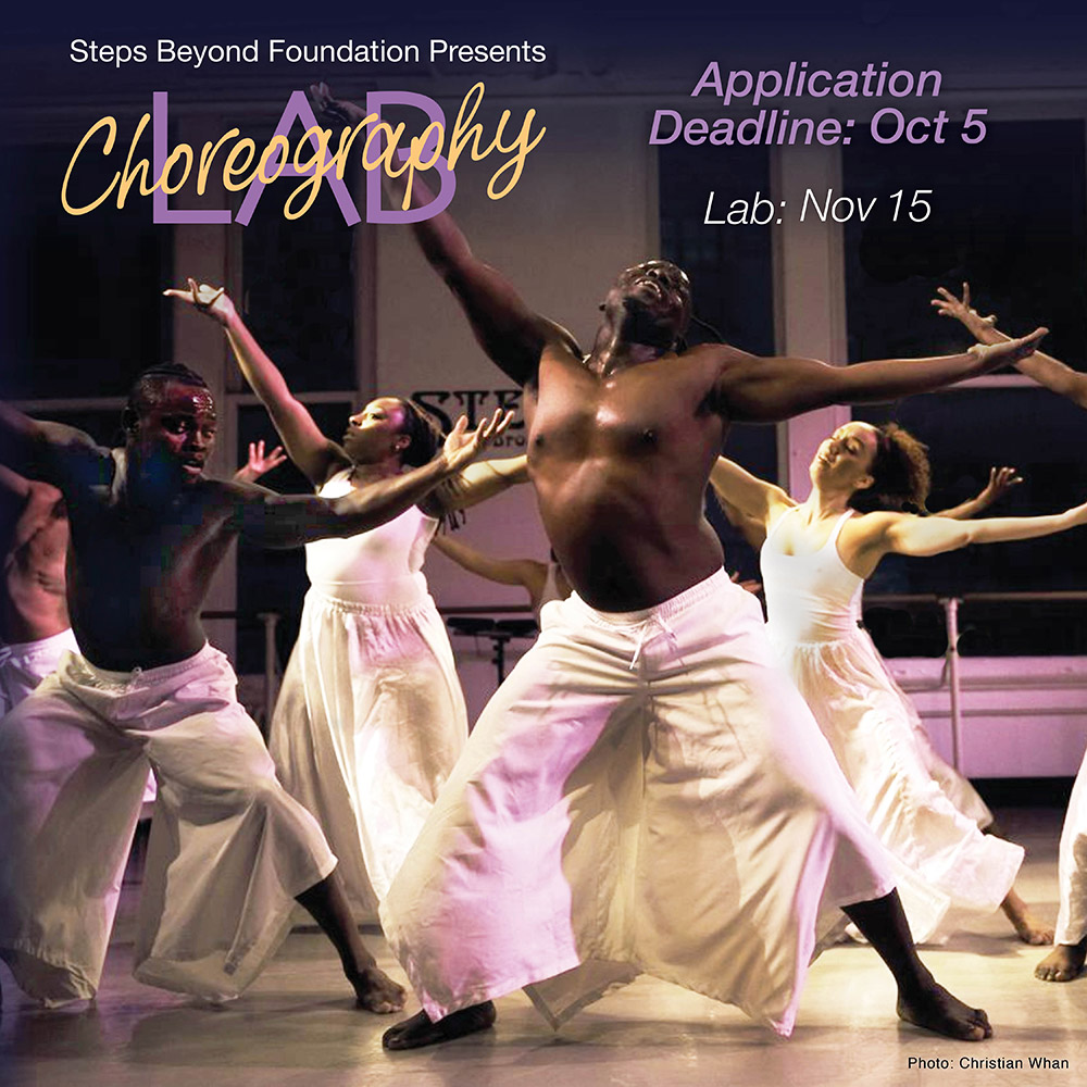 A group of dancers all in white facing the audience with arms and legs spread joyously wide